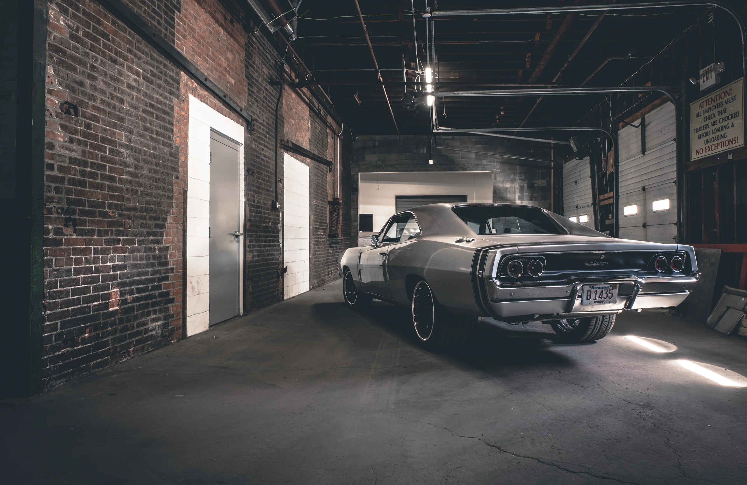 Blown Dodge Charger inside a brick industrial shop