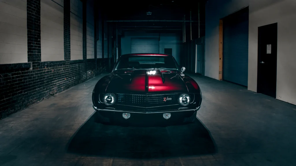 Candy red classic Chevrolet Camaro photographed indoors