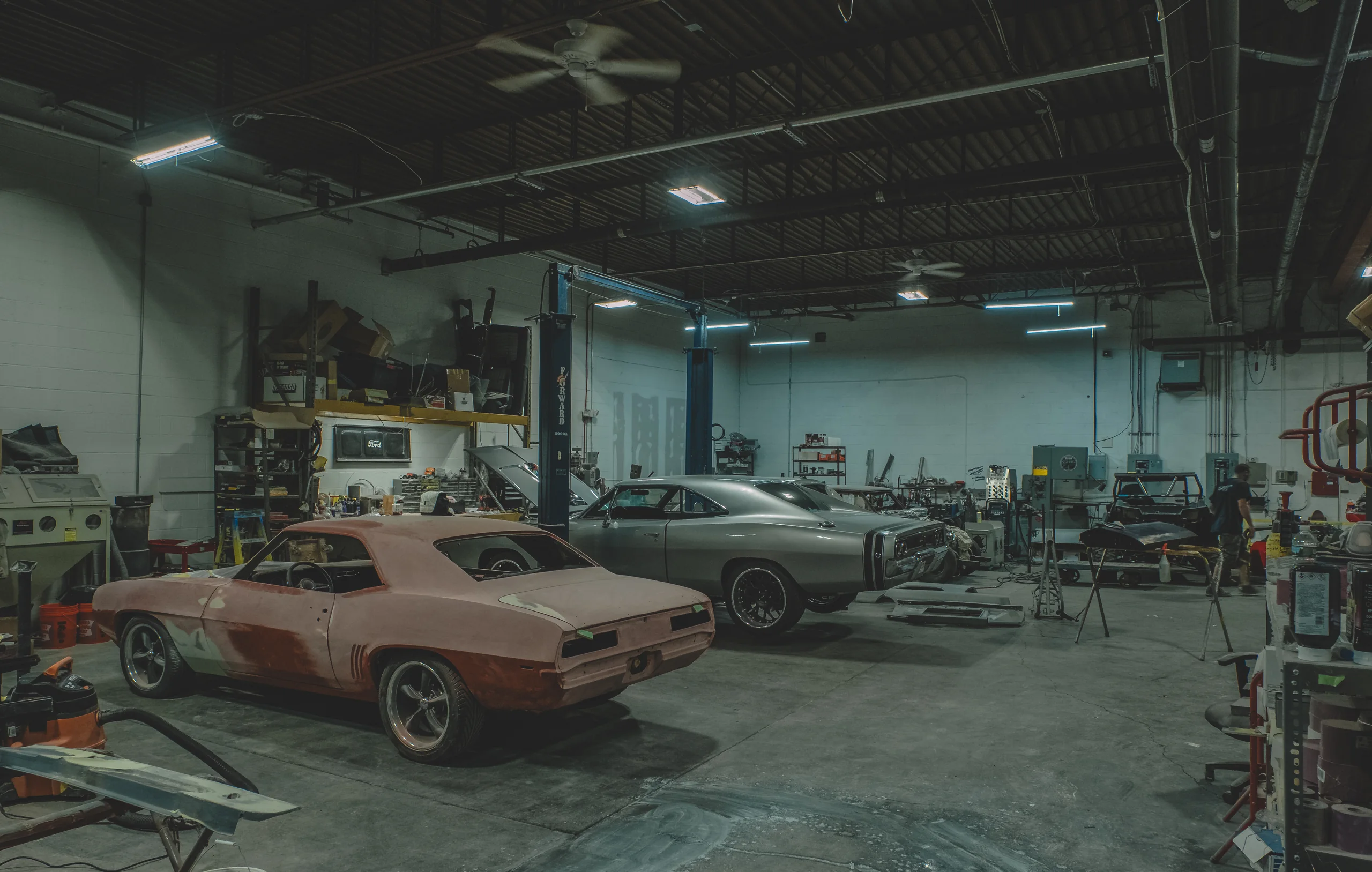 Multiple custom vehicle builds in progress inside the Chris Cerce Customs shop