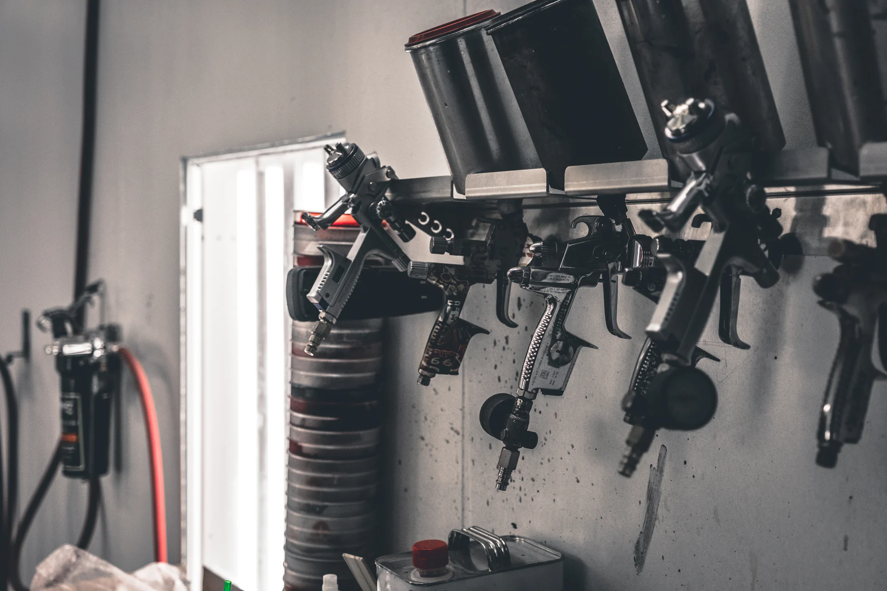 Paint spray guns mounted inside a workshop