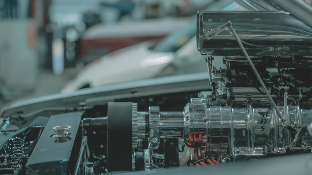 Polished supercharger and modern performance components in a custom engine bay