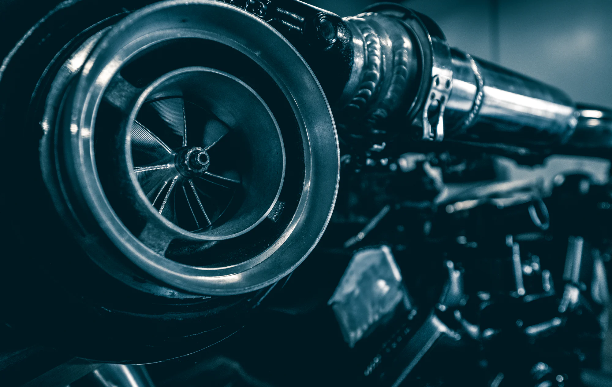 Close view of a turbocharger and polished metal tubing
