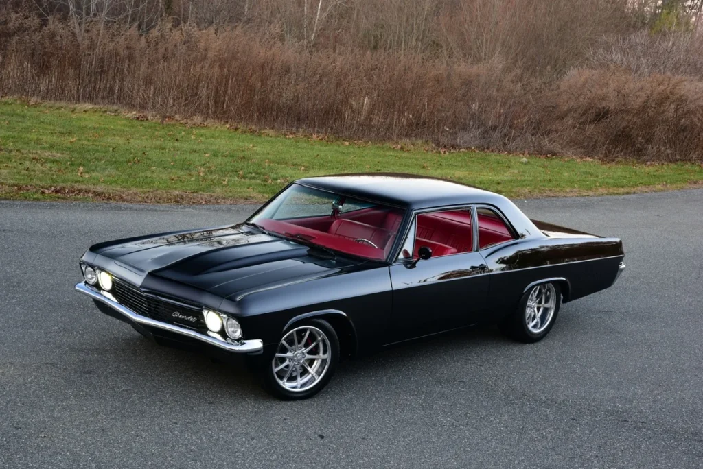 Black 1965 Chevrolet Biscayne photographed from the front three-quarter angle