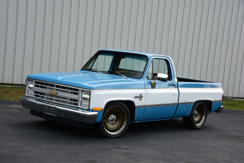 Blue and white 1983 Chevrolet C10 outside an industrial building